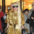 Lady Gaga dressed in  gold outfit
