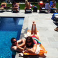 Sofia Vergara lying by a swimming pool 